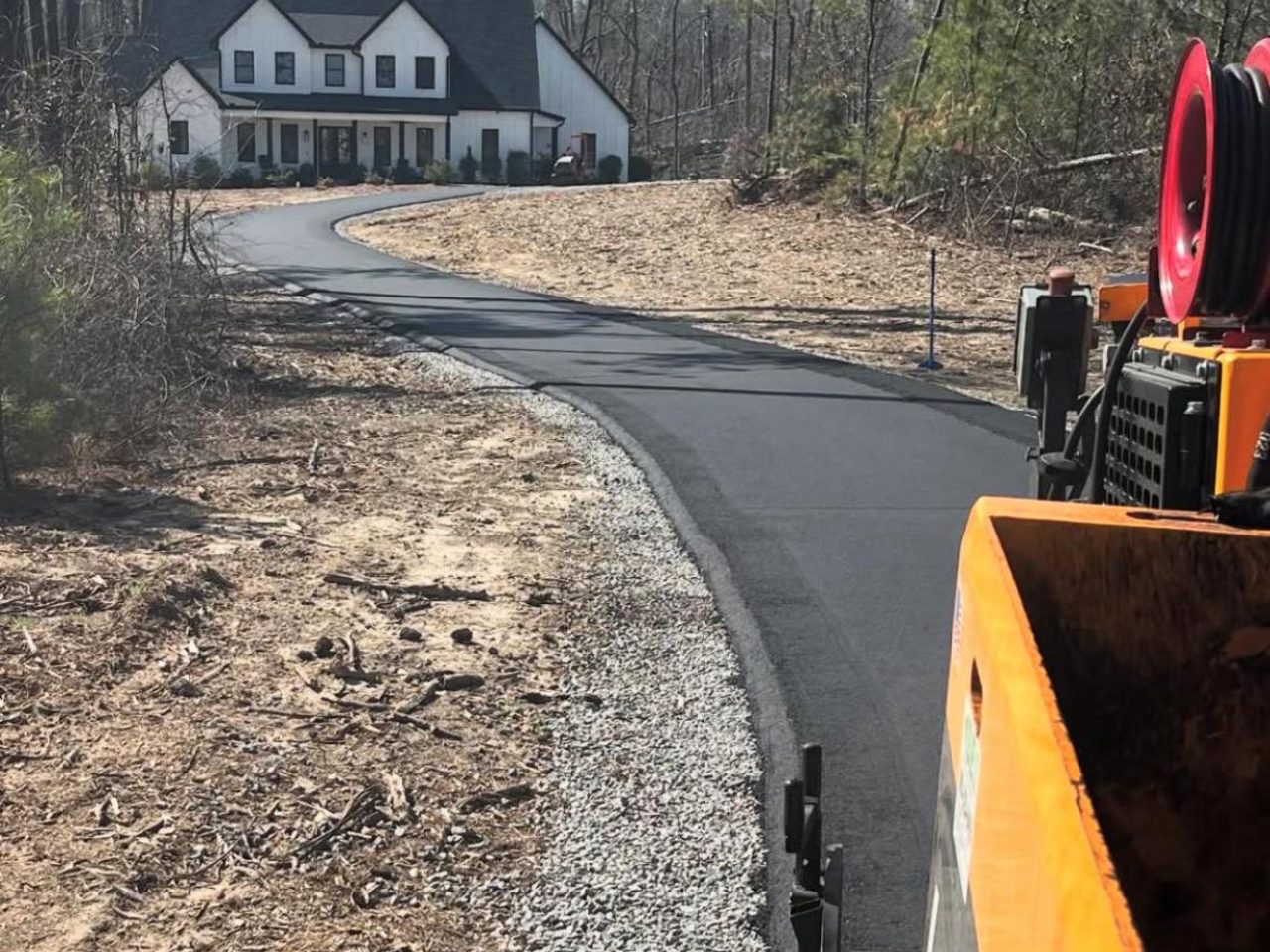 A new tarmac driveway being laid to a home
