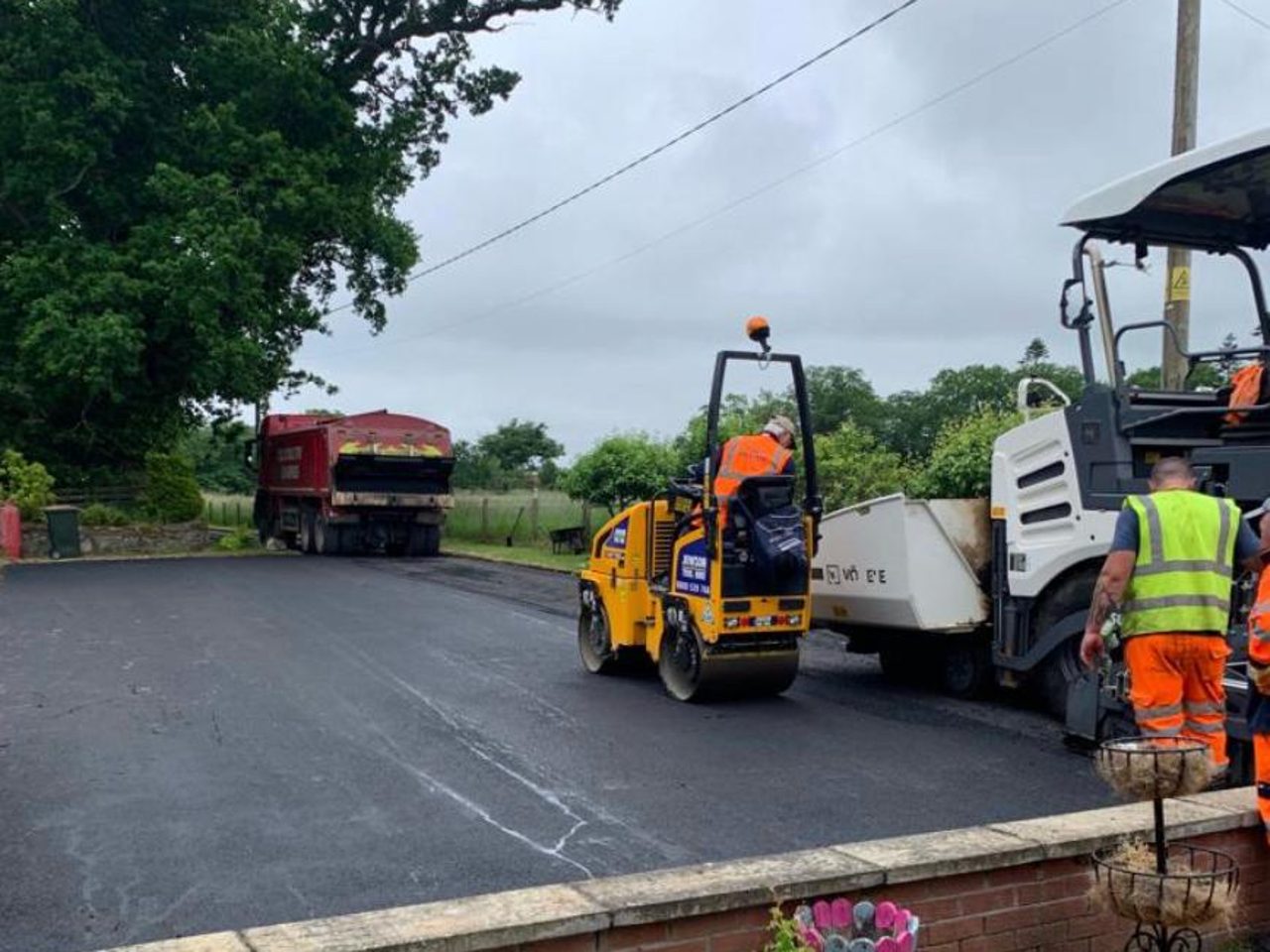 A tarmac driveway and yard being rolled